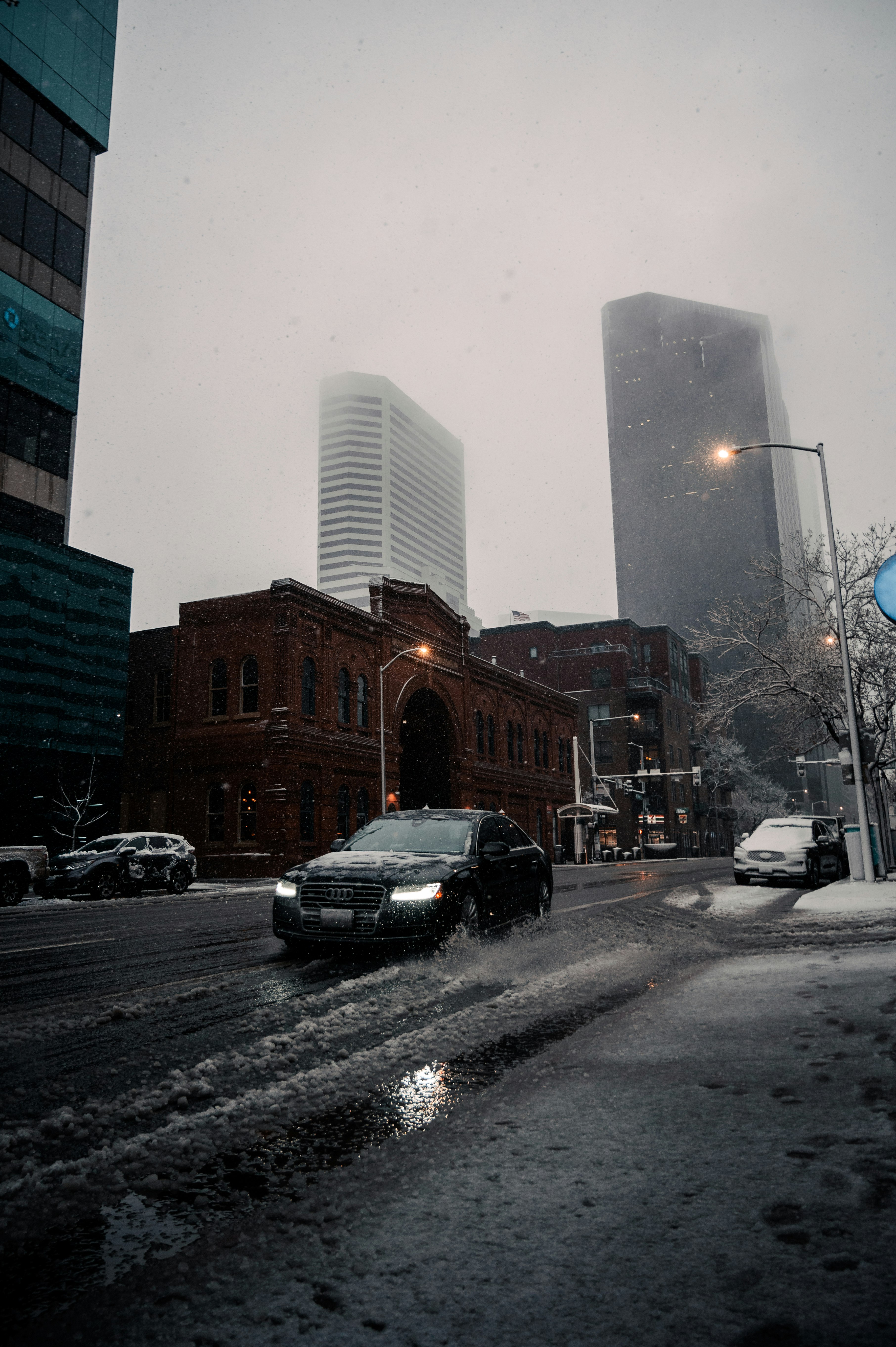 cars on road near high rise buildings during daytime